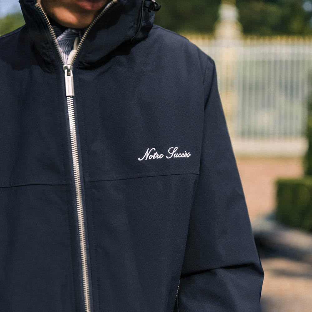 Heritage Winter Jacket in navy, embroidered Notre Succès script on the chest
