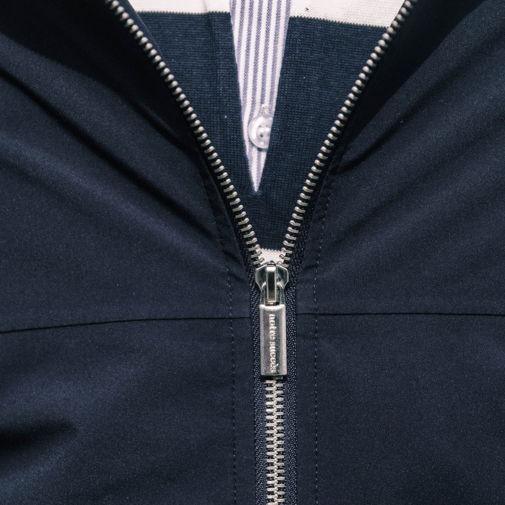 Engraved Notre Succès zip pull on the Heritage Winter Jacket